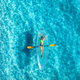 Aerial view of young woman lying on transparent canoe in blue se - PhotoDune Item for Sale