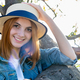 Portrait of gorgeous smiling teenage girl in yellow hat and with red hair wearing geans - PhotoDune Item for Sale