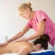 Masseuse massaging back of client in hospital - PhotoDune Item for Sale