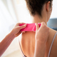 Crop osteopath applying kinesiology tape on neck of female patient in clinic - PhotoDune Item for Sale