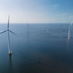 A group of windmills with turbine blades peacefully float atop the calm waters of Flevoland - PhotoDune Item for Sale