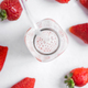Glass with a strawberry-infused drink, surrounded by fresh strawberries - PhotoDune Item for Sale