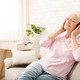 Senior woman enjoying audiobook in headphones at home - PhotoDune Item for Sale