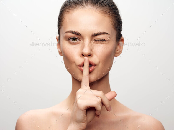 Attractive Young Woman Making Hush Hush Gesture With Finger On Lips