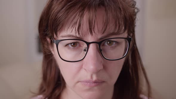 Tired Sad Woman with Glasses Looking at the Camera, Moving Camera alt