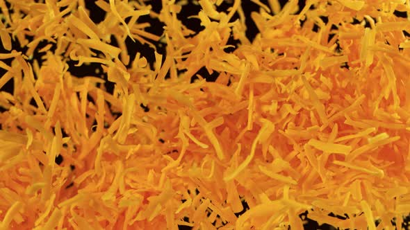Super Slow Motion Detail Shot of Flying Grated Cheddar Cheese at 1000 Fps alt