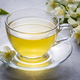 Glass cup of aromatic jasmine tea and fresh flowers - PhotoDune Item for Sale
