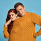 couple in yellow sweater posing against blue background cropped view - PhotoDune Item for Sale