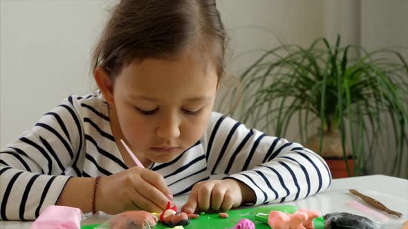 Ethnic Girl Playing with Modelling Clay