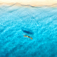 Aerial view of young woman lying on transparent canoe in blue se - PhotoDune Item for Sale