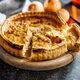 Traditional french pie. Quiche lorraine on kitchen table. - PhotoDune Item for Sale