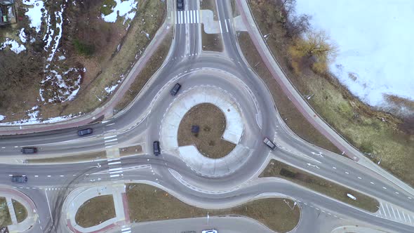 Hoovering Above Roundabout While Motor Vehicles Enters and Exits It alt