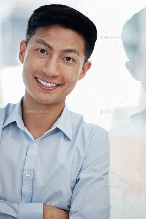 Portrait of one confident young asian business man standing with arms ...