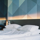Modern Bedroom Interior With Geometric Wall Design and Unmade Bed - PhotoDune Item for Sale