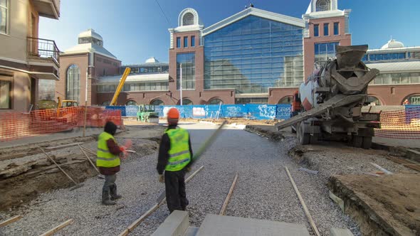Concrete Works for Road Maintenance Construction with Many Workers and Mixer Timelapse alt