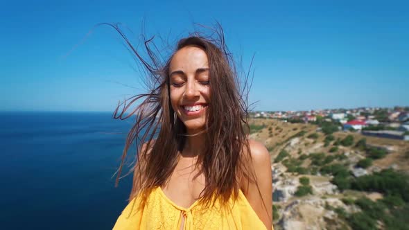 Closeup Clow Motion Portrait Beautiful Smiling Brunette Woman with Long Wind Blowing Hair alt
