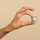 Hand holding coffee capsule on neutral background - PhotoDune Item for Sale