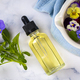 Glass bottle of essential viola oil with fresh violet flowers, alternative medicine - PhotoDune Item for Sale