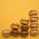 Chocolate macarons on a yellow background, dessert. Top view - PhotoDune Item for Sale