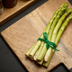 Fresh green asparagus sprouts on a black wooden background. View from above - PhotoDune Item for Sale