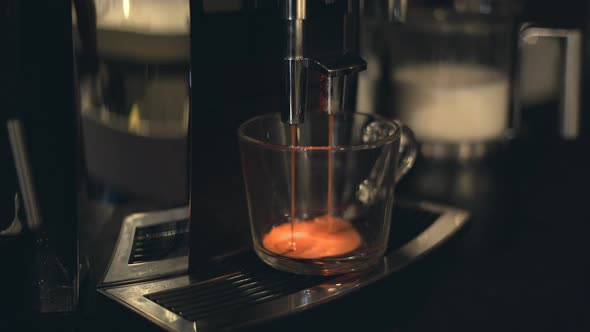 Freshly Brewed Coffee Dripping Into Cup From Coffee Machine Portafilter alt