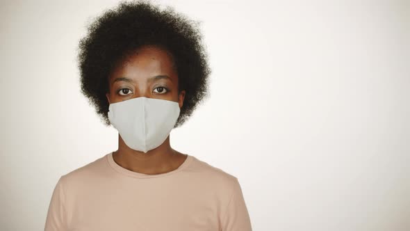 Confident Black Woman in Protective Face Mask Posing for Camera alt