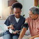 Elderly man, living room and nurse with blood pressure for heart rate, cardiovascular support or ex - PhotoDune Item for Sale
