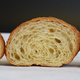 freshly baked croissant cut in half to show inside - PhotoDune Item for Sale