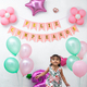 girl running forward, surrounded by balloons and with a happy birthday sign in Spanish - PhotoDune Item for Sale