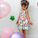 little latina girl looking at her feet and posing like a professional model, surrounded by balloons. - PhotoDune Item for Sale