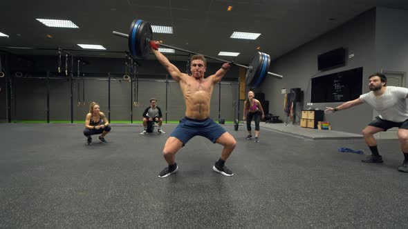 Disabled athlete lifting weights with people cheering in background