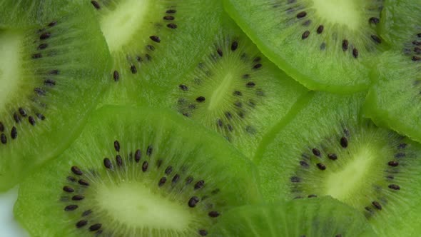 Juicy Green Kiwi Fruit or Chinese Gooseberry Background in the Form of Sliced Kiwi Spins alt