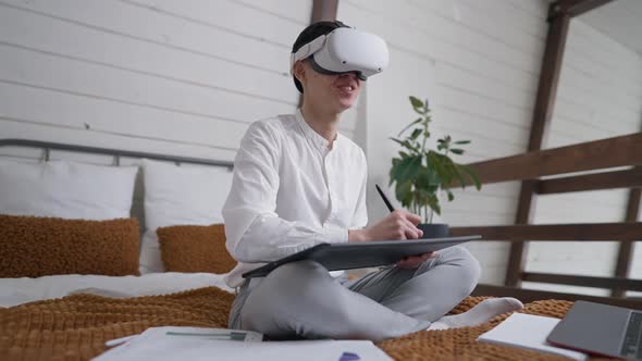 Side Angle View of Positive Talented Creative Asian Designer in VR Headset Drawing Sketch on alt