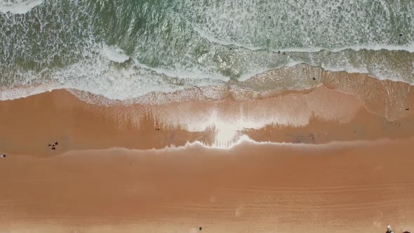 Topdown upwards waves crashing at beach shore, Natal, Brazilian coastline alt