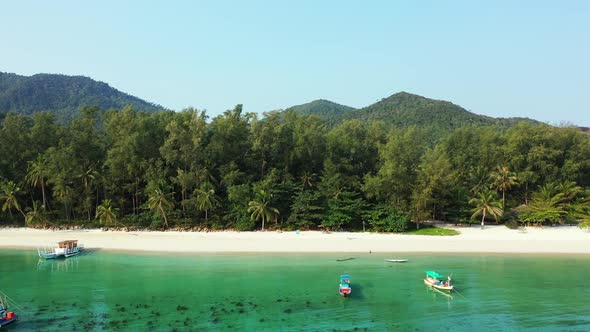 Peaceful vacation bay with calm turquoise lagoon full of fishing boats near white sand of exotic bea alt