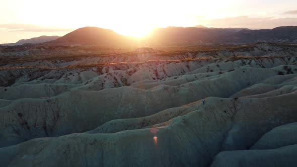 Dunes landscape desert drone aerial point of view of woman walking in deserts of Mahoya in Spain alt
