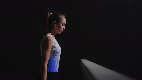 Competition of Junior Gymnasts Teen Girl is Standing Near Balance Beam Preparing to Start alt
