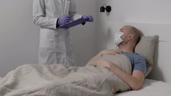 Male Patient Is Answering on Questions of Doctor in Clinic During Epidemic of Flu, Man Is Lying alt