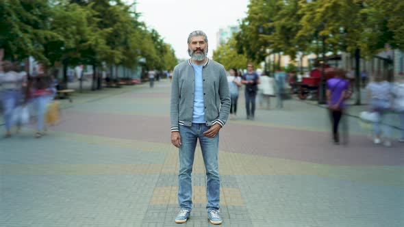 Time Lapse of Goodlooking Mature Man in Trendy Clothing Standing Outdoors in Busy Street alt