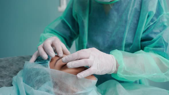 Closeup Shot of Surgeon Performing Rhinoplasty in Green Protective Gowns