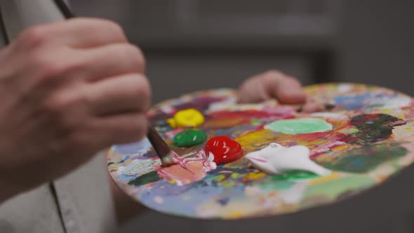 Artist Loading Brush With Color alt