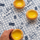 Person&#39;s hand holding an egg tart on the table - PhotoDune Item for Sale