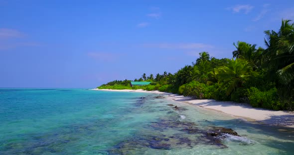 Wide angle birds eye island view of a sunshine white sandy paradise beach and blue ocean background  alt