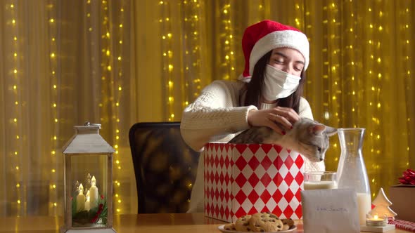 Woman Opening Christmas Present Adorable Cat Inside