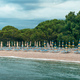 Folded beach umbrellas and empty deck chairs on town beach in Crikvenica, Croatia - PhotoDune Item for Sale
