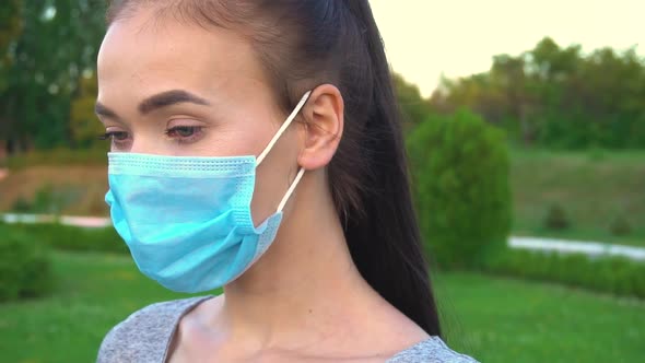 Portrait of Woman Weared in Face Medical Mask Outdoor Close Up