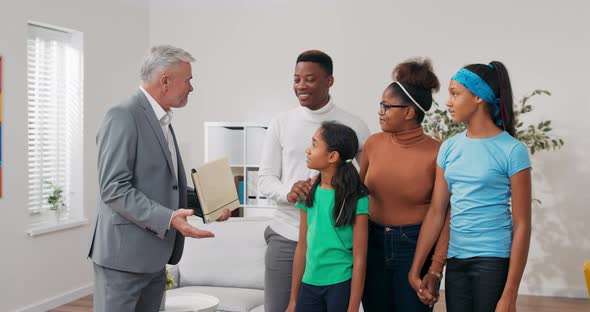 Family Decides to Rent an Apartment They Meet with an Experienced Real Estate Agent a Man with Gray alt