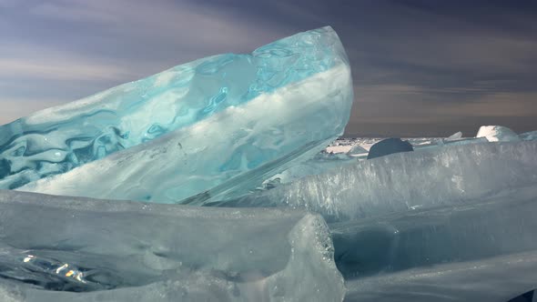 Blue Broken Ice Floe on Frozen Surface of Baikal Lake