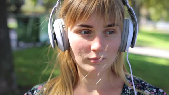 Woman Blonde Listening Music with Headphones alt
