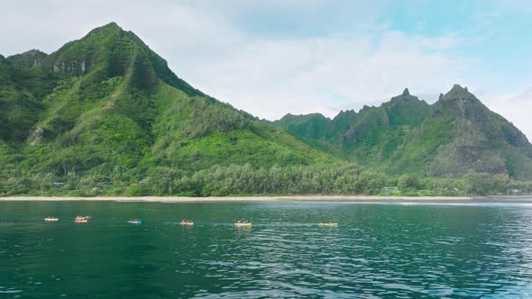 Kayakers on Green Mountain Background Napali Park Coast Kauai Island Hawaii alt